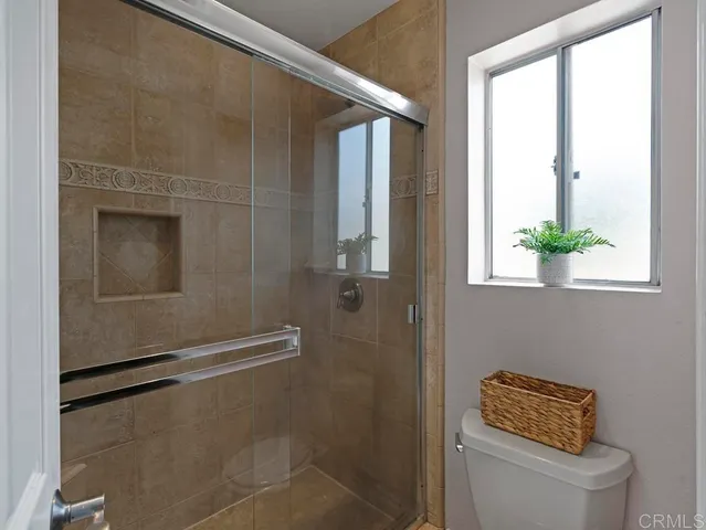 a bathroom with a toilet and a shower