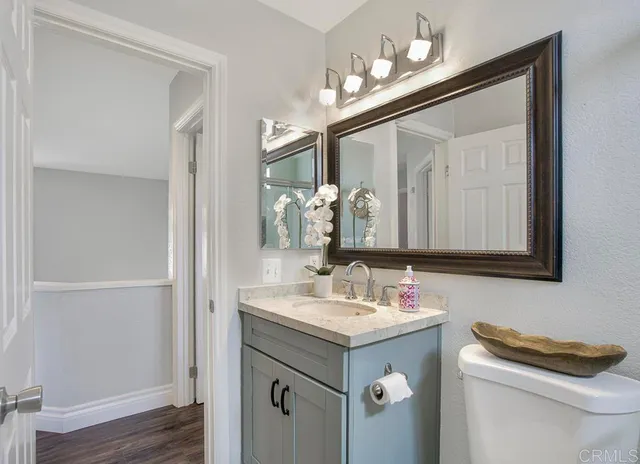 a bathroom with a sink vanity and a mirror