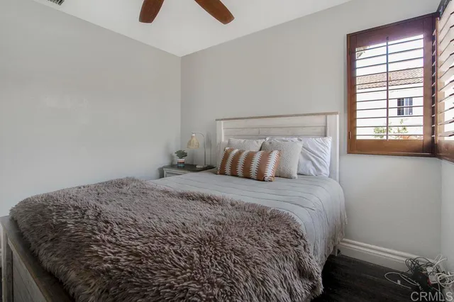 a bedroom with a bed and window