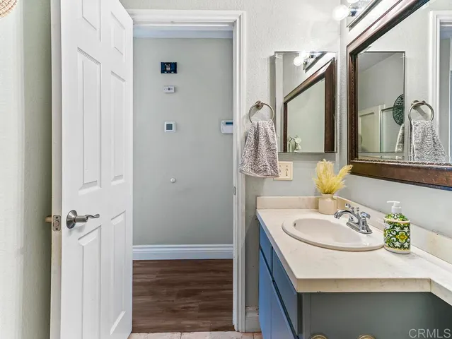a bathroom with a sink a mirror and a shower