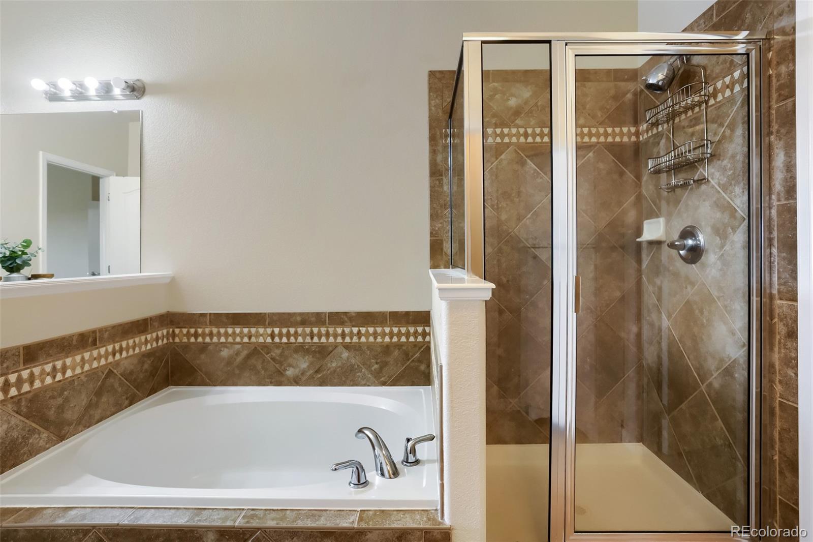 6232 Kilmer Loop, Unit 203 Golden, CO 80403 - Photo 23 of 33 a bathroom with a bathtub and shower
