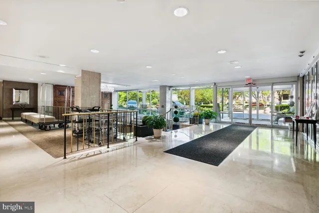 a lobby with furniture and glass door
