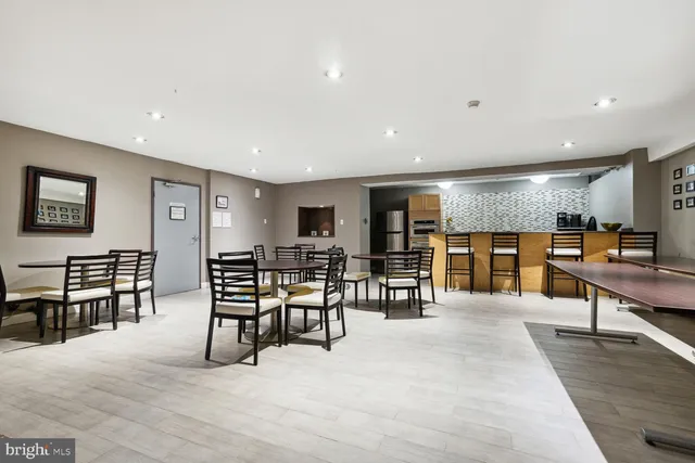 a living room with lots of furniture and kitchen view