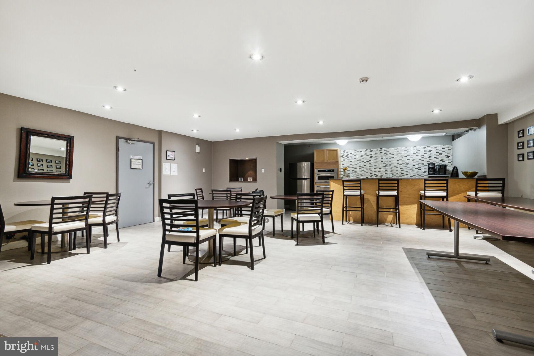 1900 Lyttonsville Road, Unit 702 Silver Spring, MD 20910 - Photo 13 of 20 a living room with lots of furniture and kitchen view