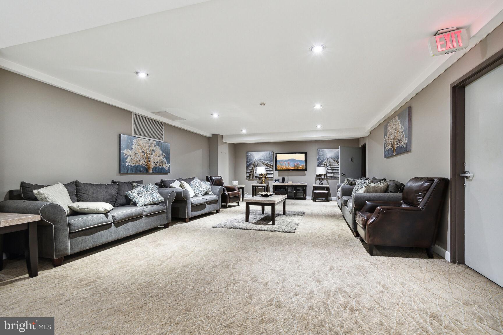 1900 Lyttonsville Road, Unit 702 Silver Spring, MD 20910 - Photo 14 of 20 a living room with furniture and a flat screen tv