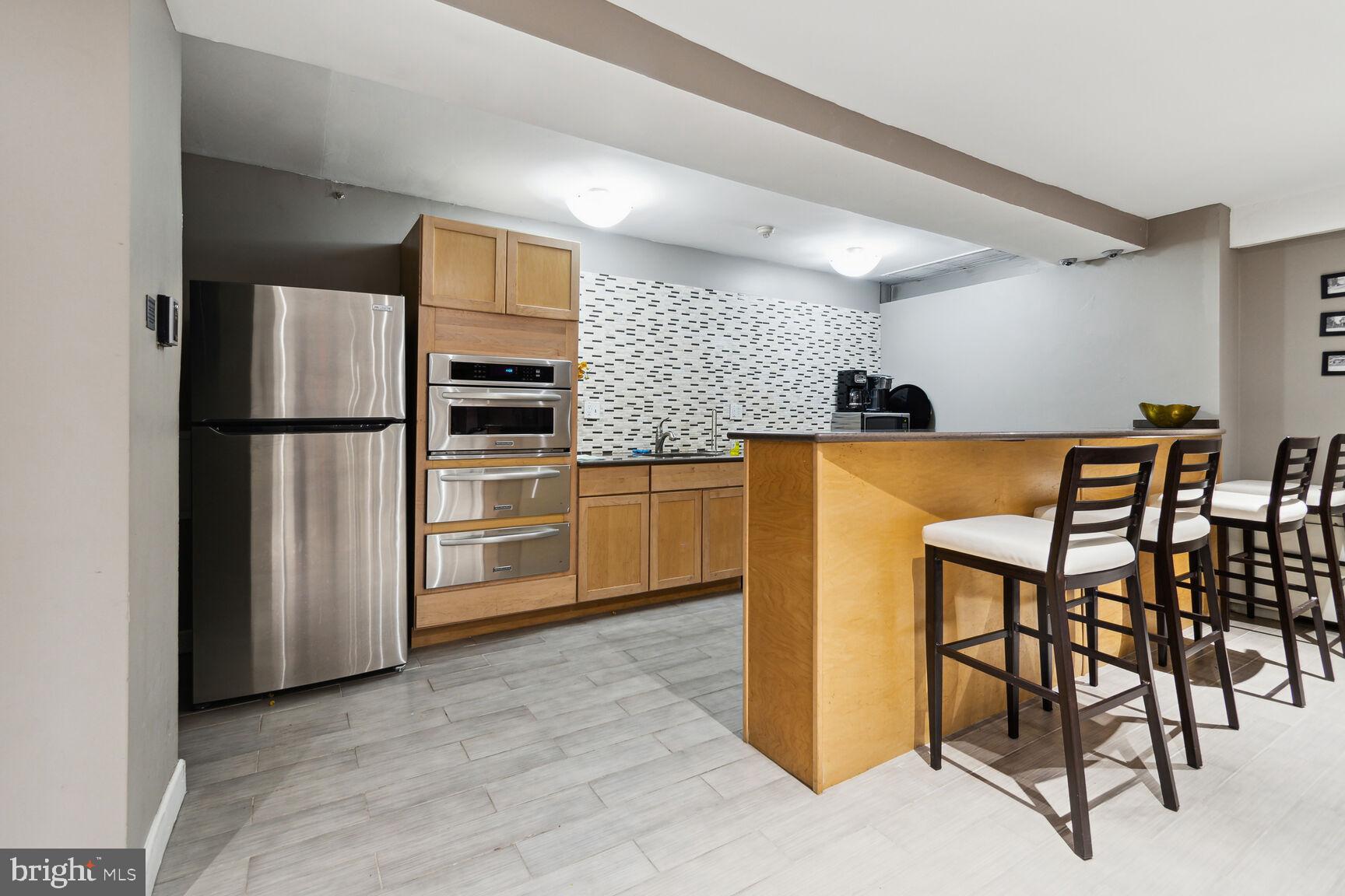 1900 Lyttonsville Road, Unit 702 Silver Spring, MD 20910 - Photo 15 of 20 a kitchen with stainless steel appliances a refrigerator and a stove top oven
