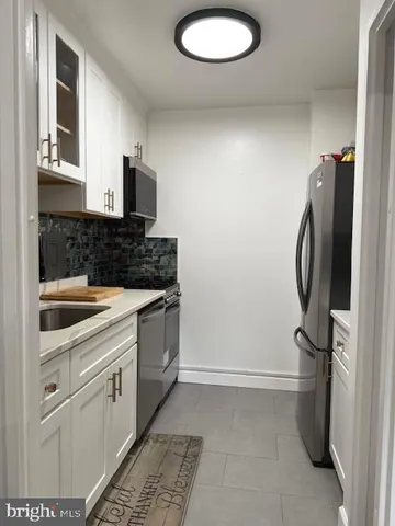 a kitchen with a refrigerator and a sink