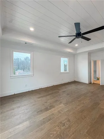 a view of an empty room with window and bathroom