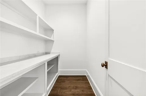 an entryway with ceiling fan and windows