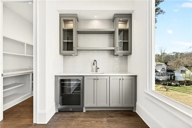 an entryway with ceiling fan and windows