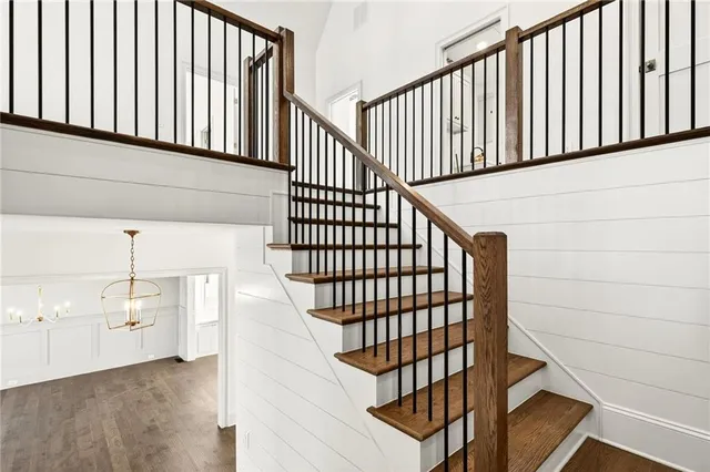 a view of a big room with wooden floor and windows