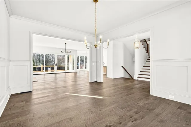 a view of a room with wooden floor and windows