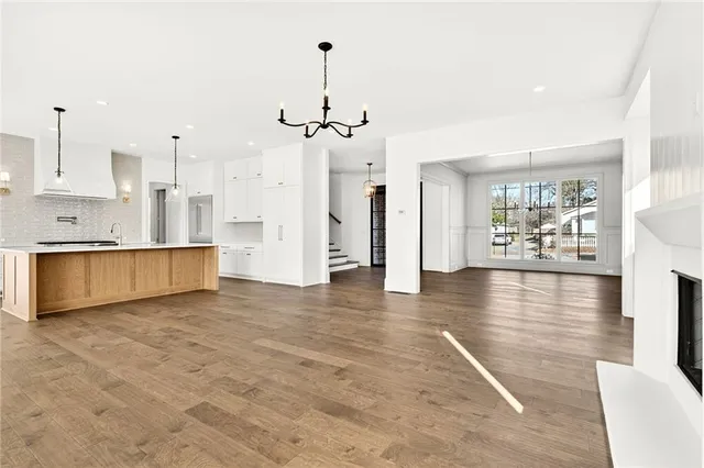 a view of a kitchen with wooden floor and a kitchen