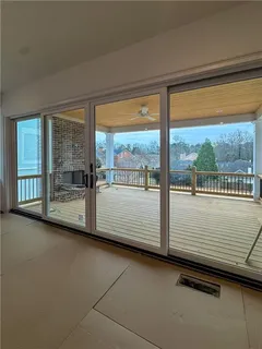 a view of balcony with wooden floor and floor to ceiling window