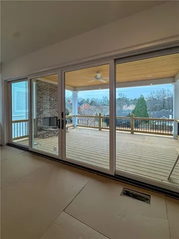 a view of balcony with wooden floor and floor to ceiling window