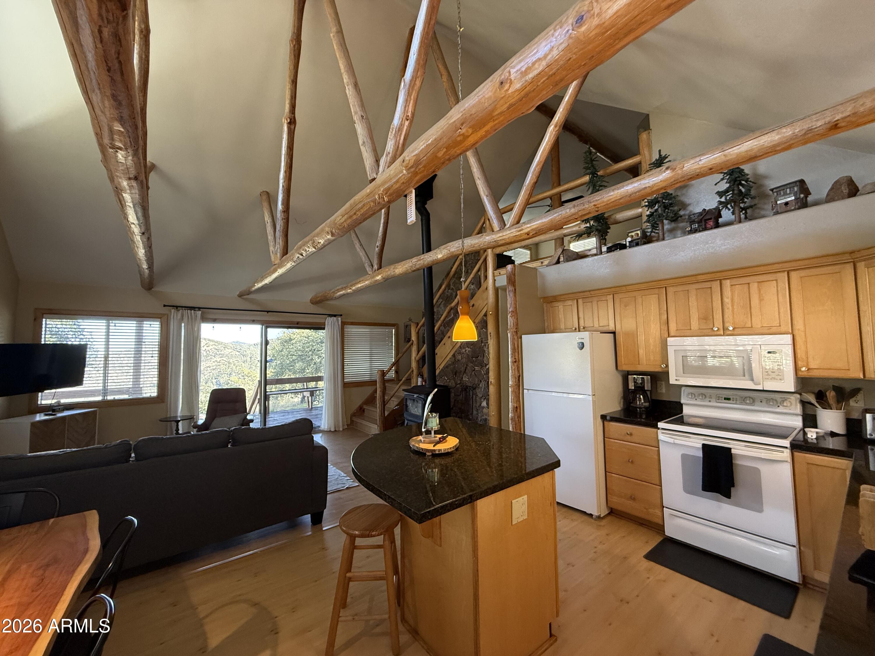 23487 Manzanita Road Crown King, AZ 86343 - Photo 12 of 41 a kitchen with stainless steel appliances kitchen island granite countertop a refrigerator a stove a sink dishwasher and white countertops with cabinets