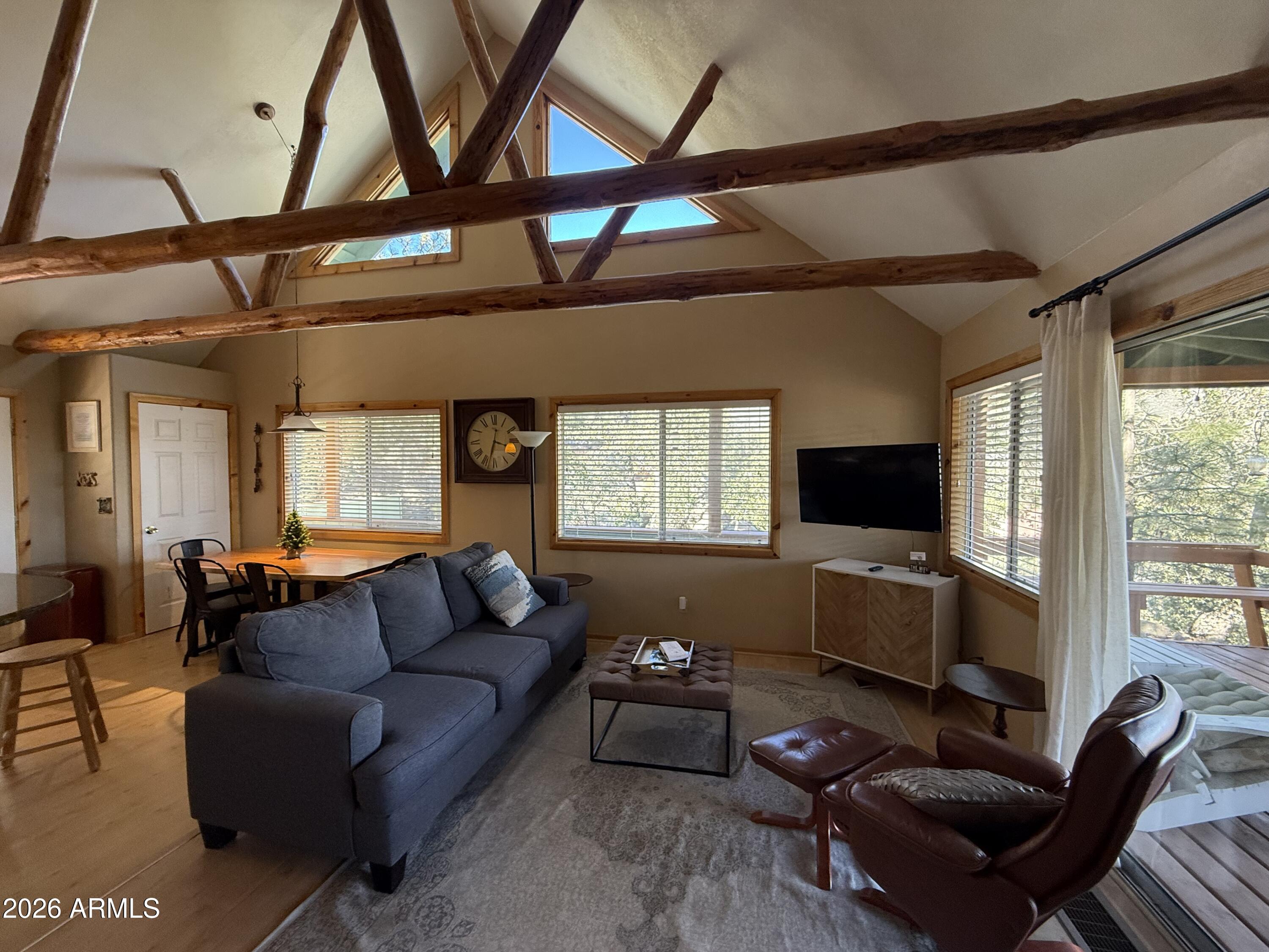 23487 Manzanita Road Crown King, AZ 86343 - Photo 14 of 41 a living room with furniture a flat screen tv and a window