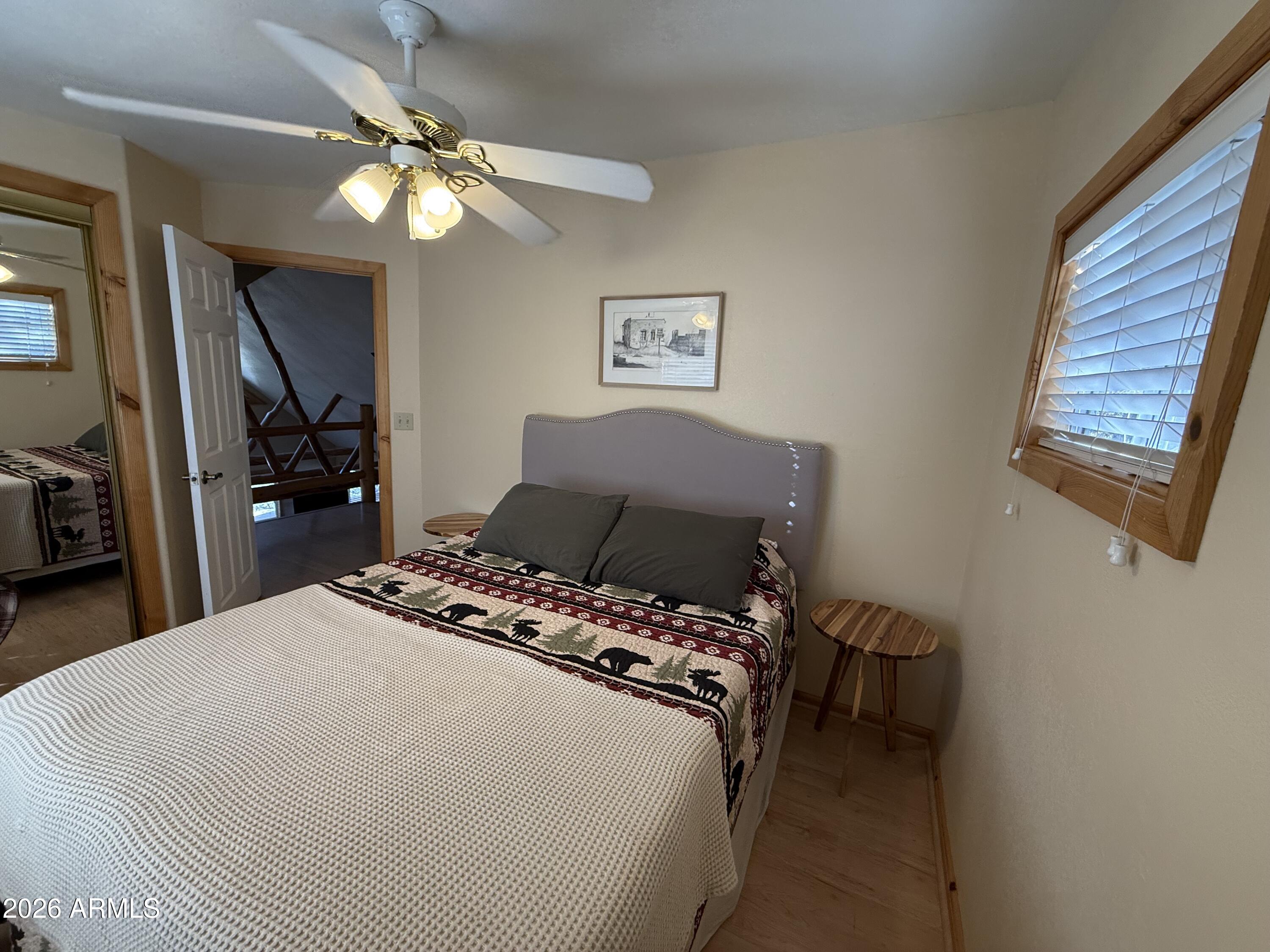 23487 Manzanita Road Crown King, AZ 86343 - Photo 17 of 45 a bedroom with a bed and a chandelier