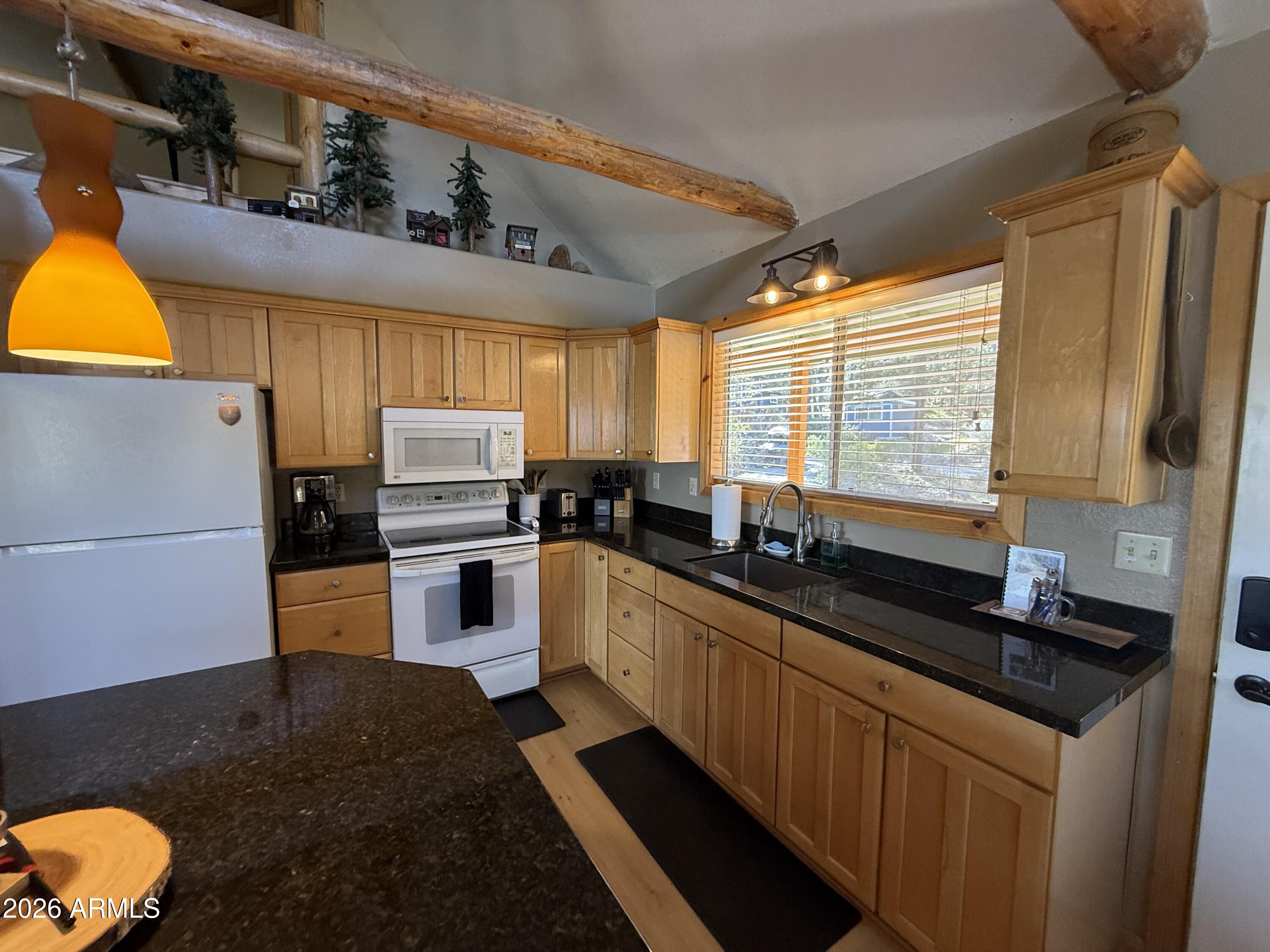 23487 Manzanita Road Crown King, AZ 86343 - Photo 2 of 41 a kitchen with granite countertop a sink a counter space cabinets and appliances