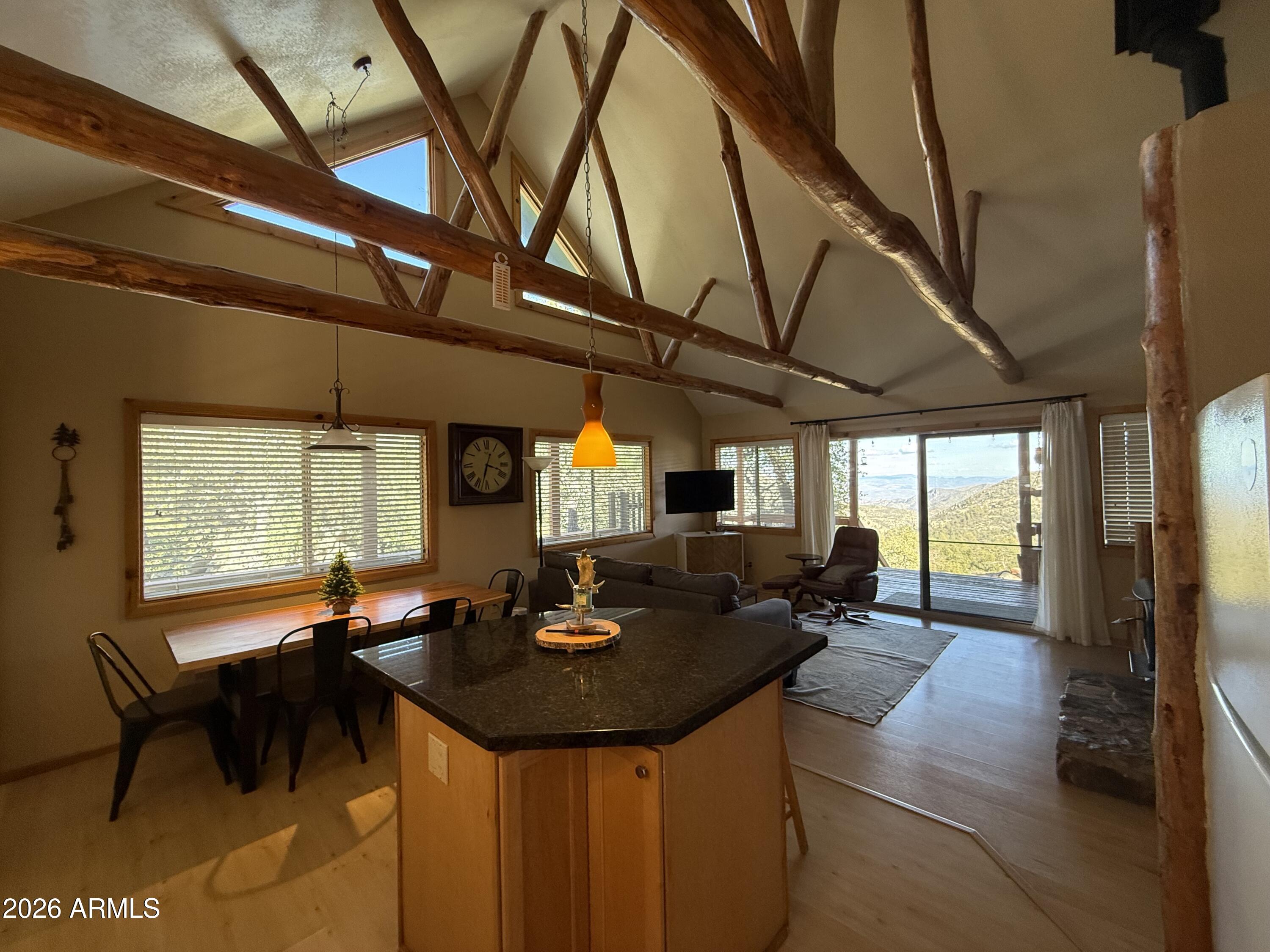 23487 Manzanita Road Crown King, AZ 86343 - Photo 21 of 41 a kitchen with a table chairs and wooden floor