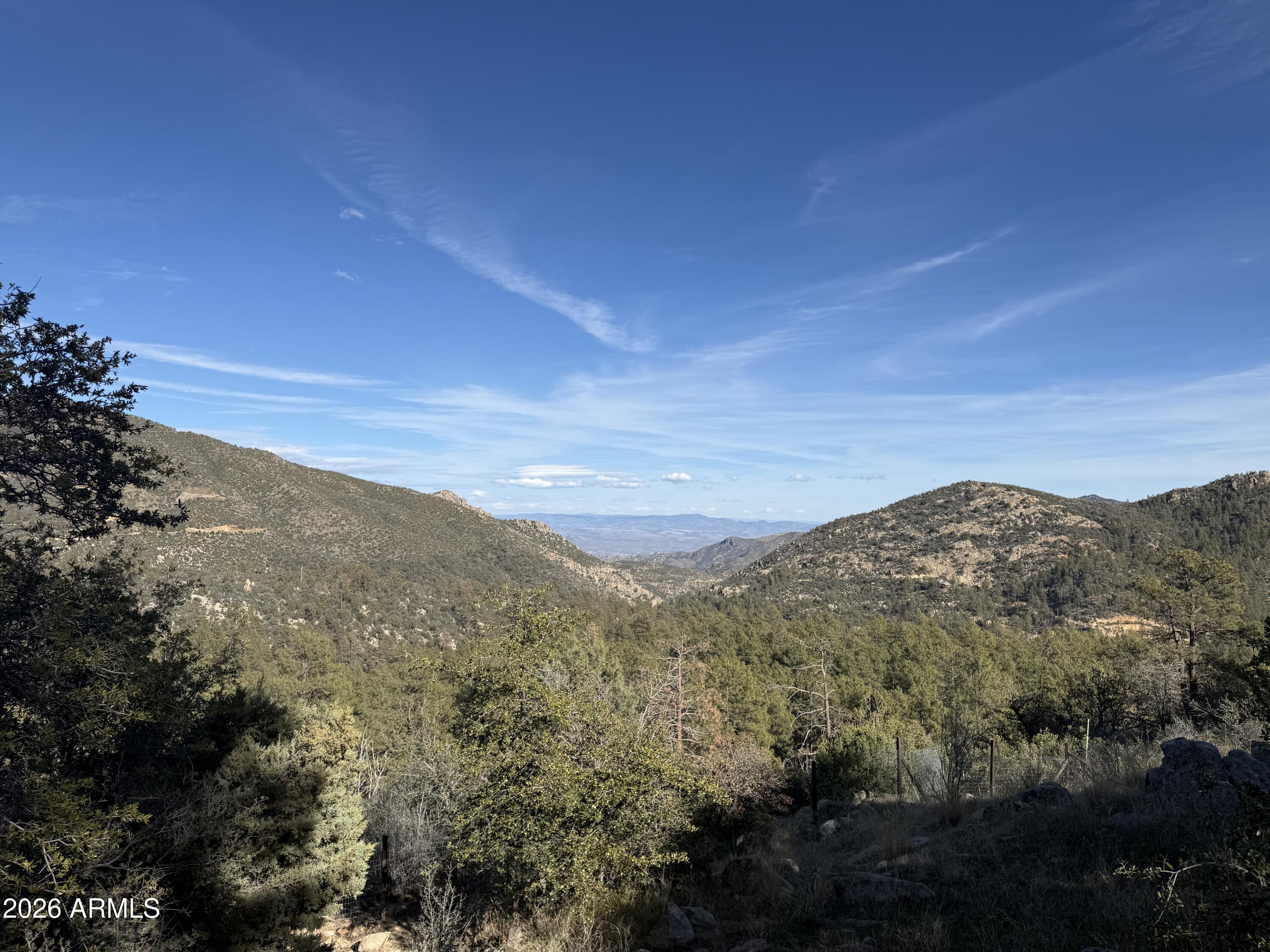 23487 Manzanita Road Crown King, AZ 86343 - Photo 24 of 41 a view of a mountain range in a cloudy sky