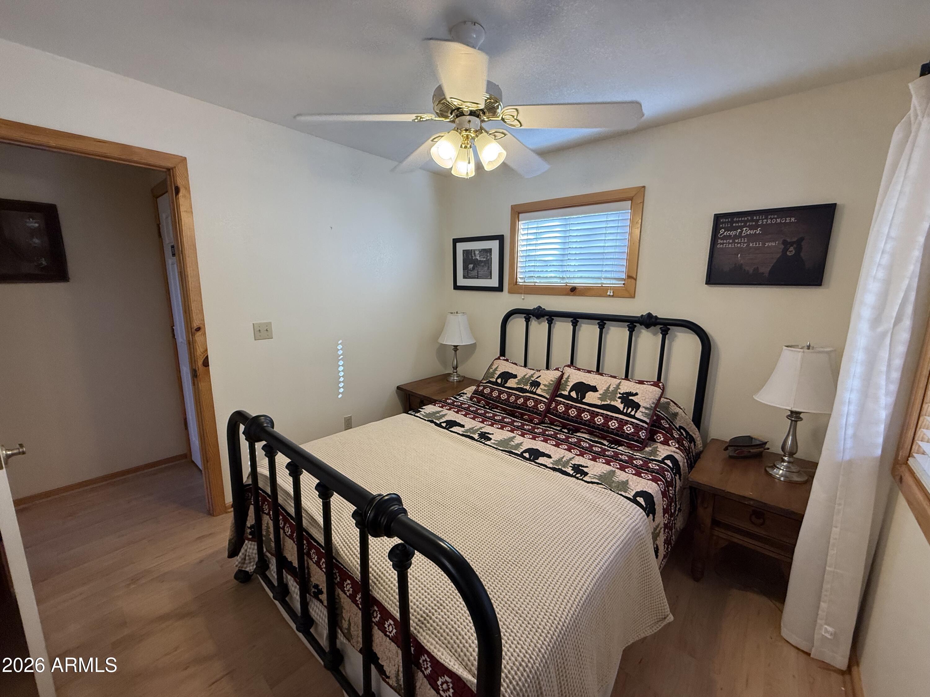 23487 Manzanita Road Crown King, AZ 86343 - Photo 30 of 41 a bedroom with a bed and a chandelier