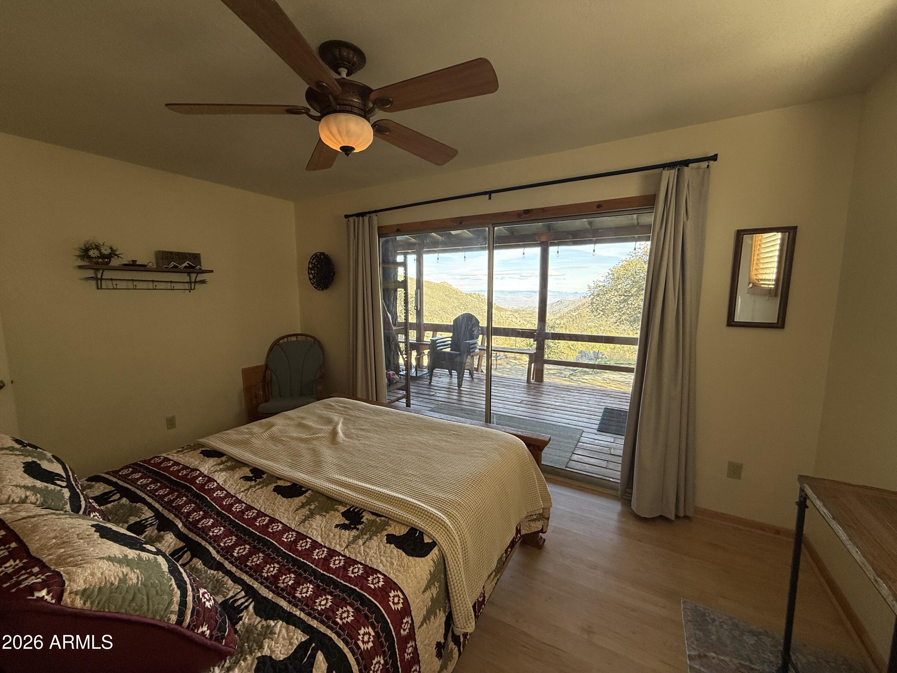 23487 Manzanita Road Crown King, AZ 86343 - Photo 30 of 45 a bedroom with a bed and a window