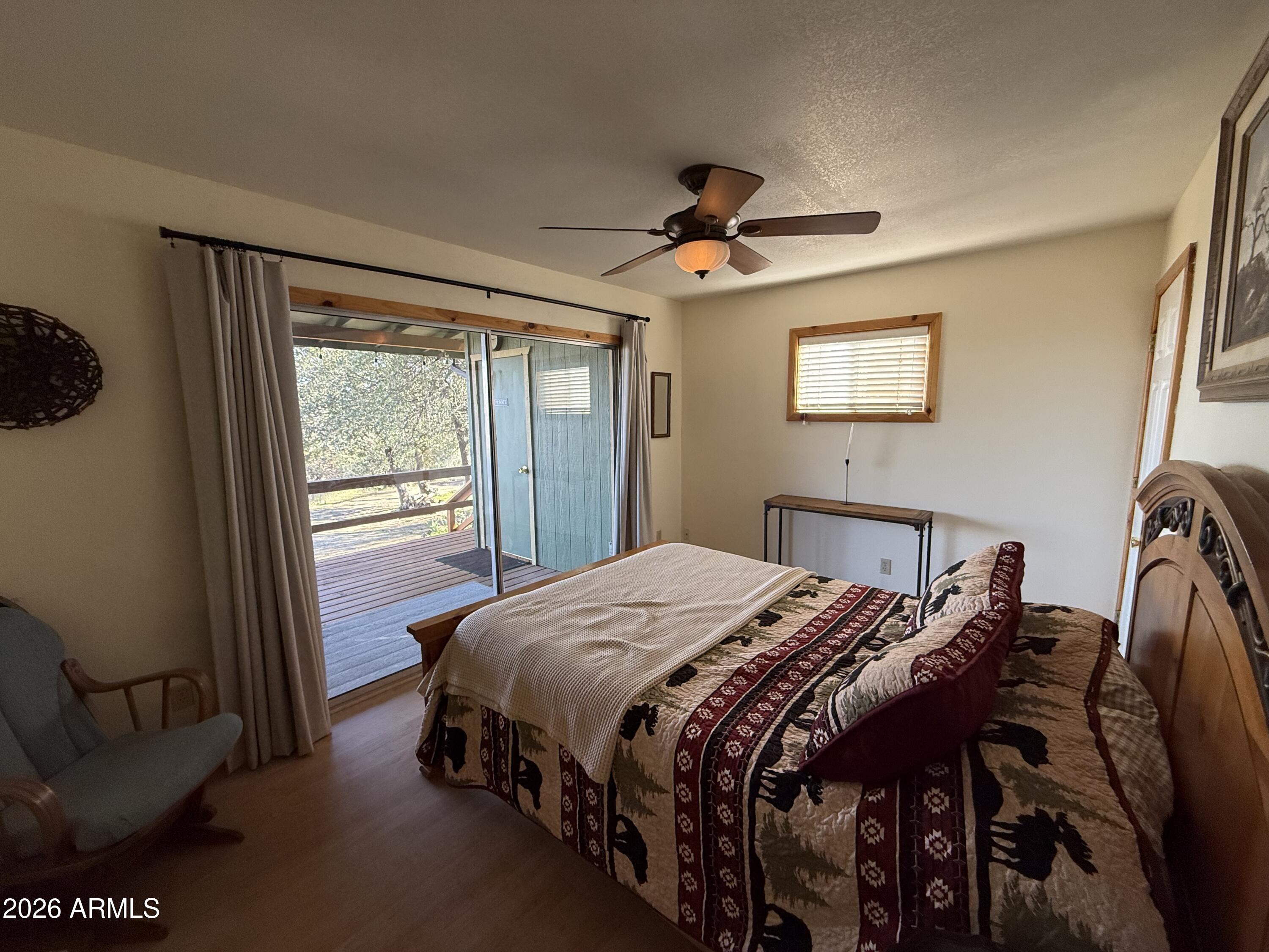 23487 Manzanita Road Crown King, AZ 86343 - Photo 31 of 45 a bedroom with a bed a window and a couch