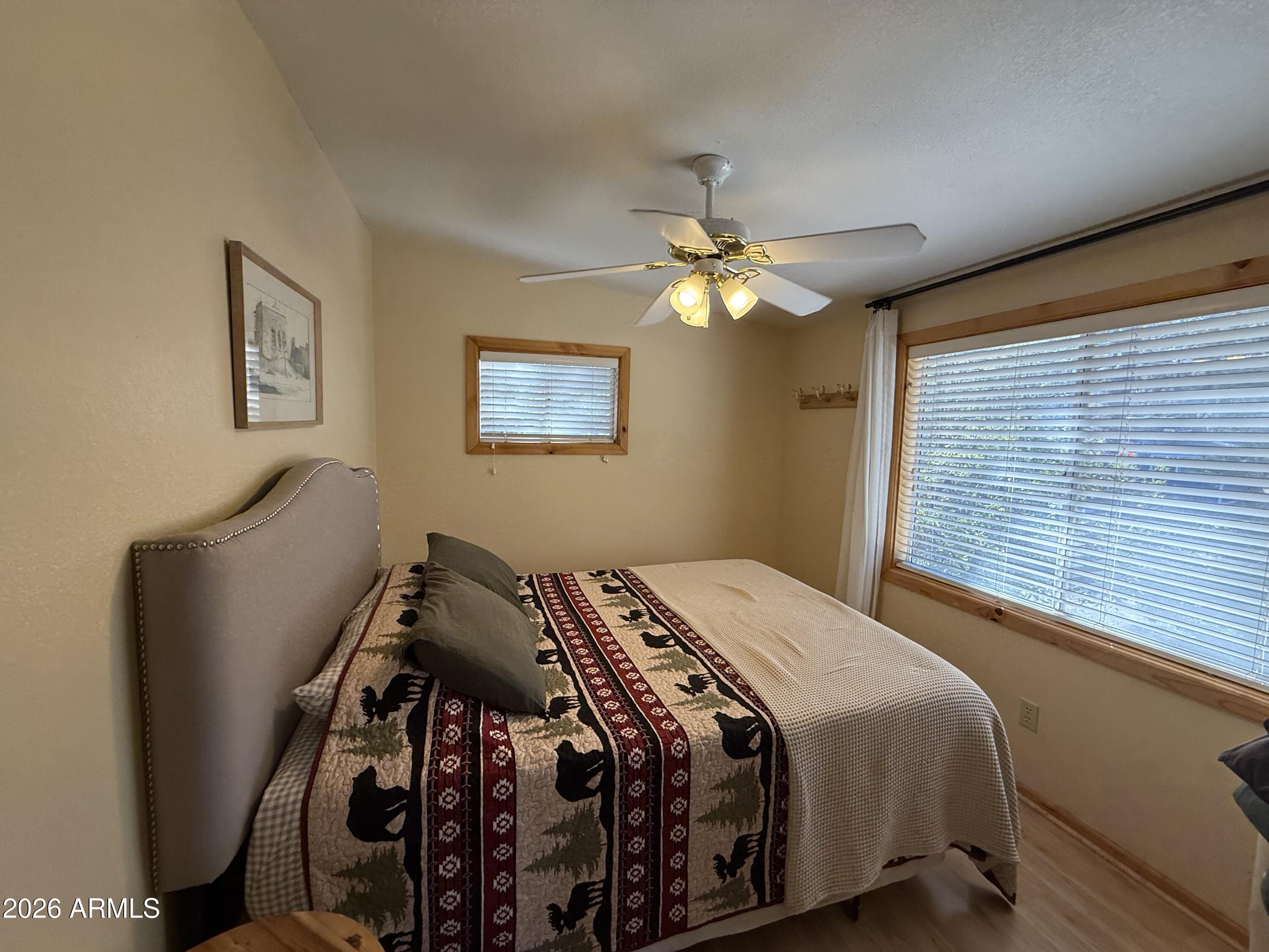 23487 Manzanita Road Crown King, AZ 86343 - Photo 37 of 45 a bedroom with a bed and a chandelier