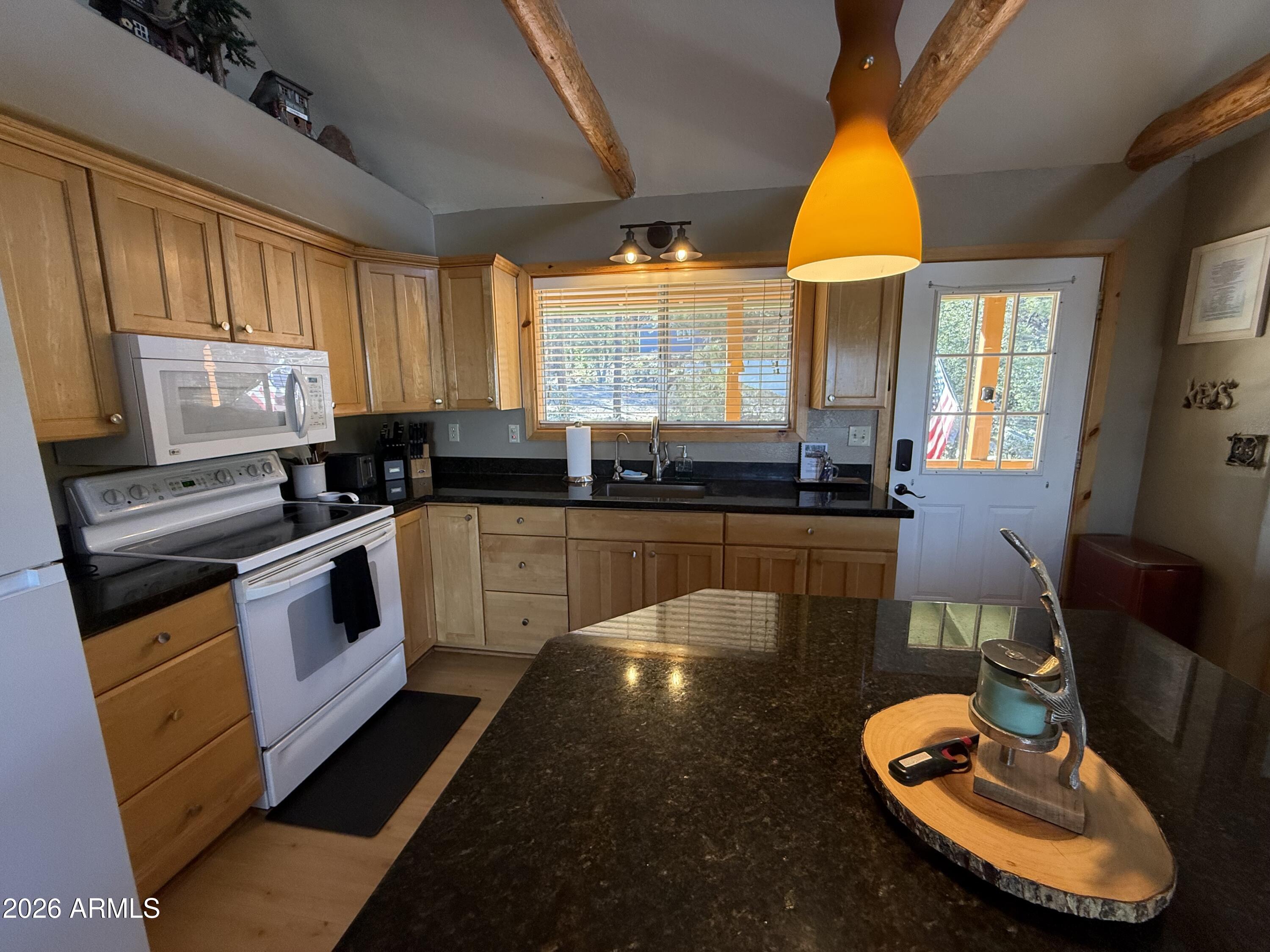 23487 Manzanita Road Crown King, AZ 86343 - Photo 40 of 45 a kitchen with stainless steel appliances a stove a sink a microwave cabinets and wooden floor