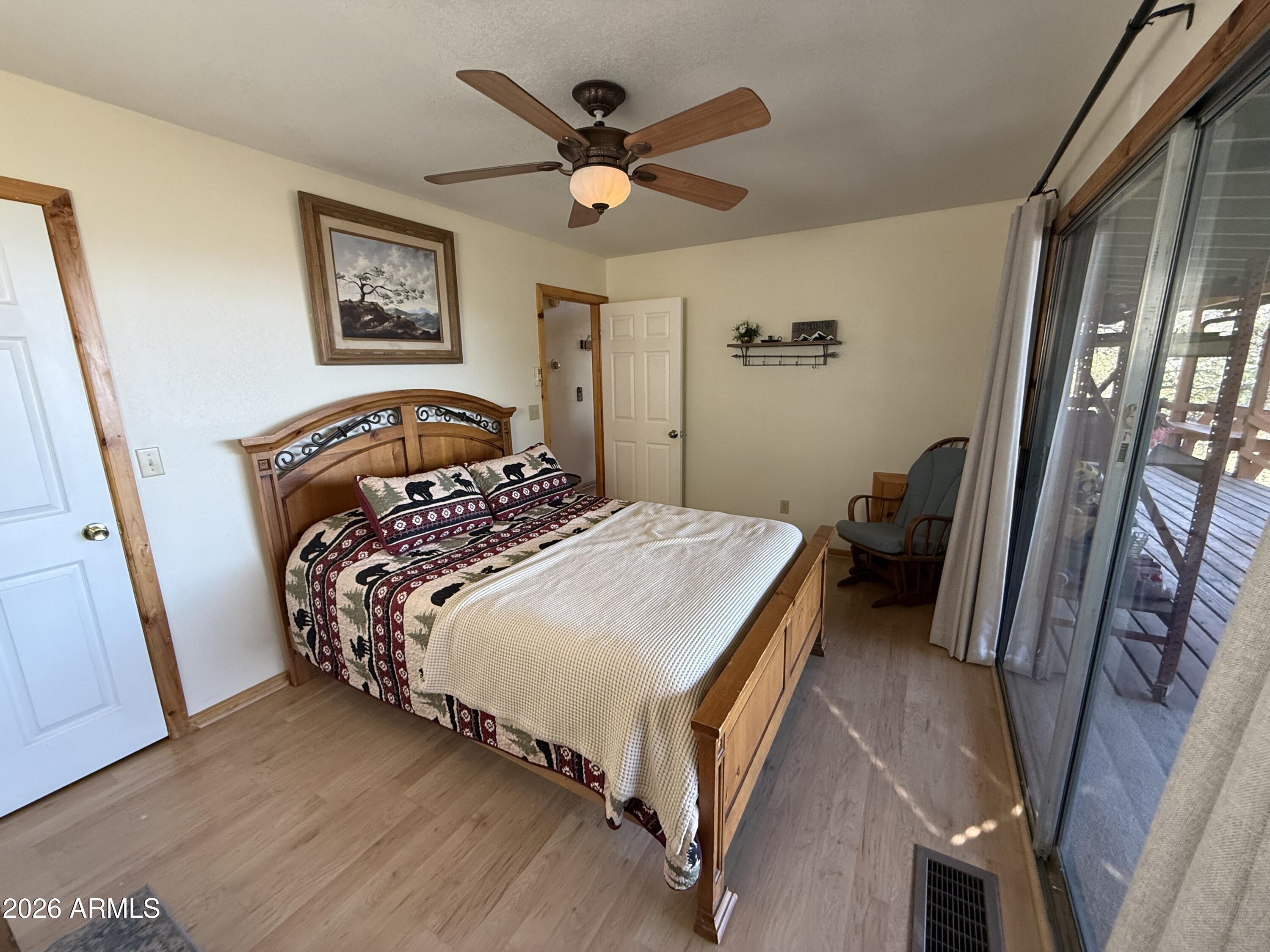 23487 Manzanita Road Crown King, AZ 86343 - Photo 4 of 41 a bedroom with a bed and a painting on the wall