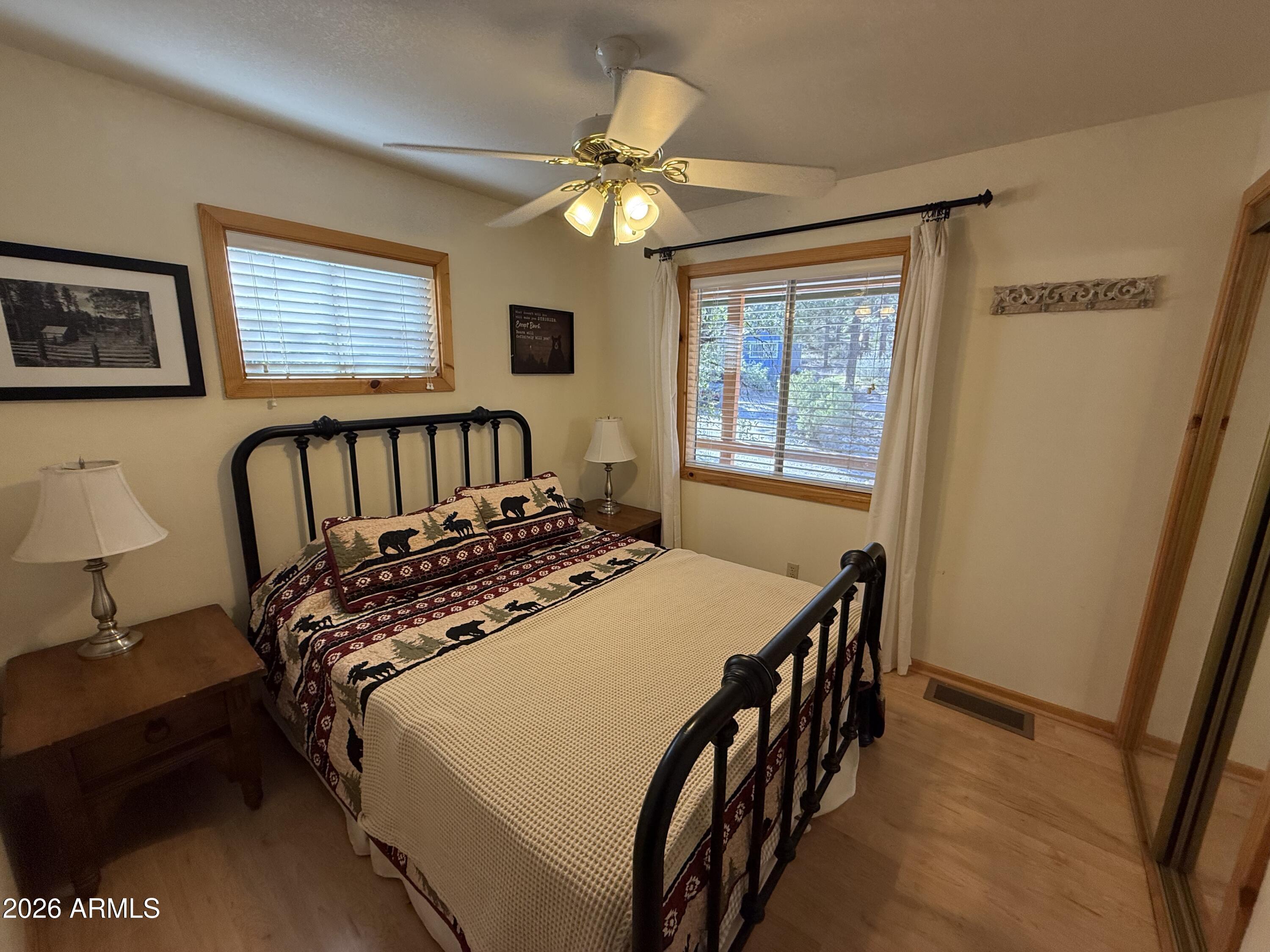 23487 Manzanita Road Crown King, AZ 86343 - Photo 6 of 41 a bedroom with a bed and a chandelier