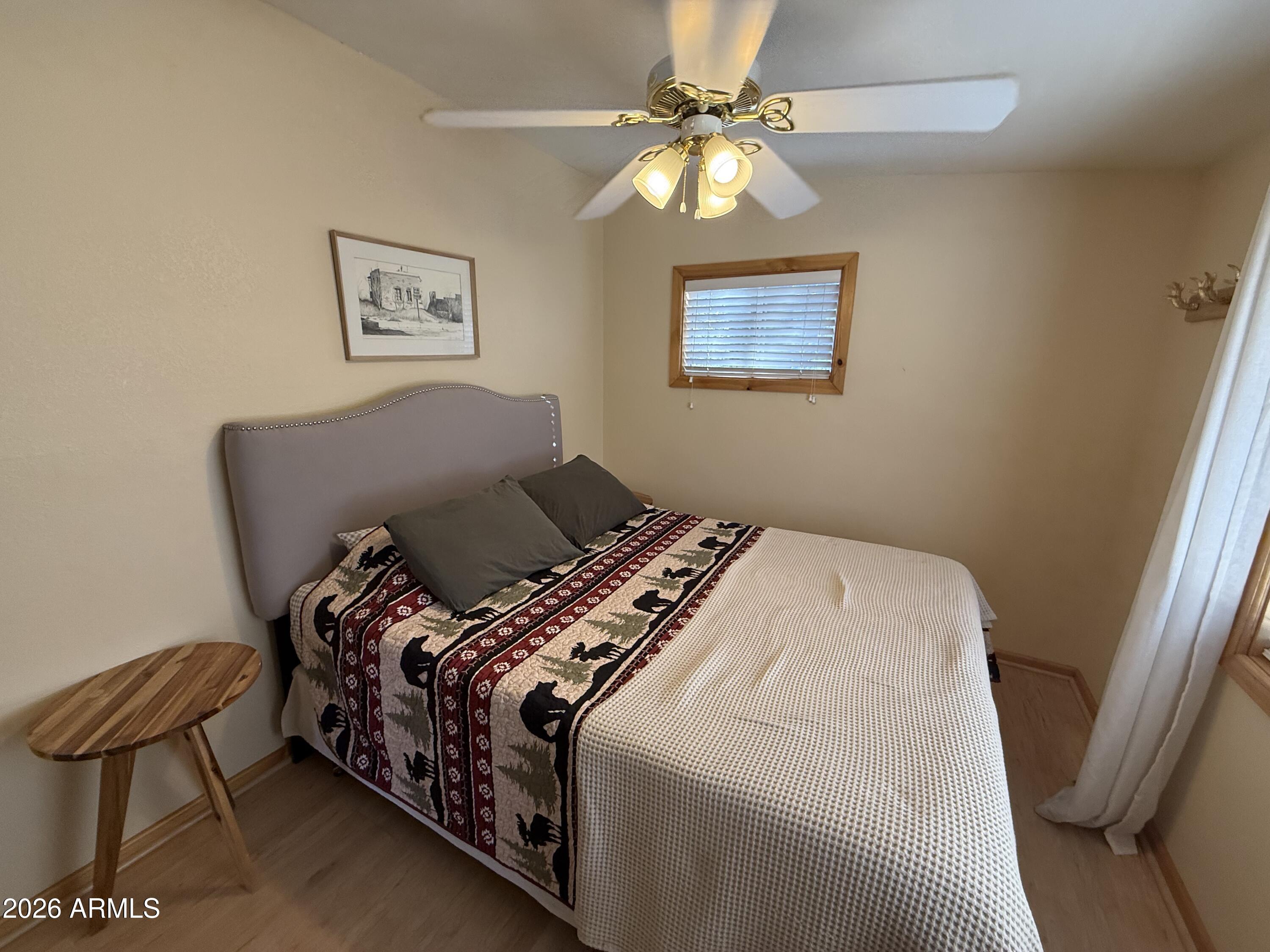 23487 Manzanita Road Crown King, AZ 86343 - Photo 7 of 41 a bedroom with a bed and a chandelier