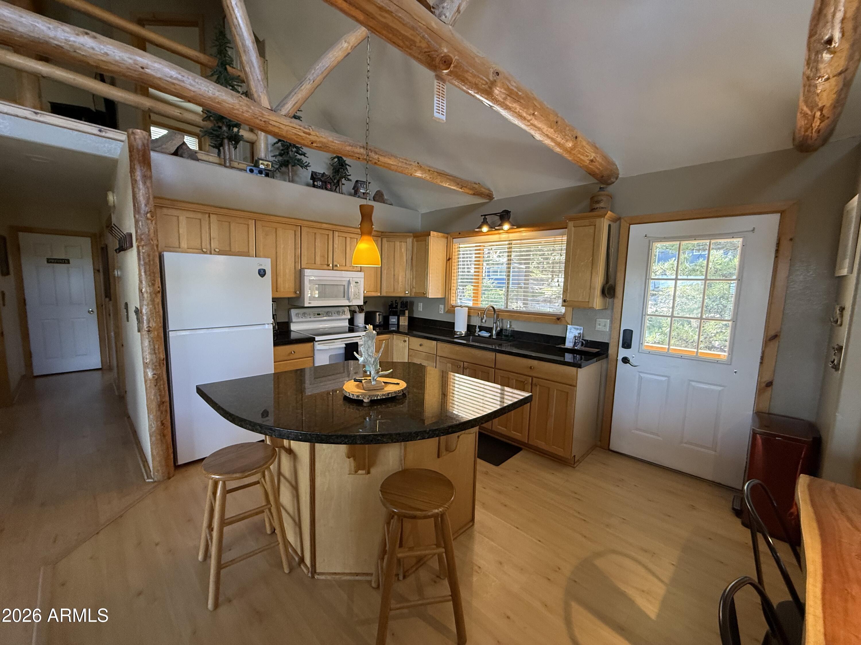 23487 Manzanita Road Crown King, AZ 86343 - Photo 8 of 41 a view of a dining room with furniture and window