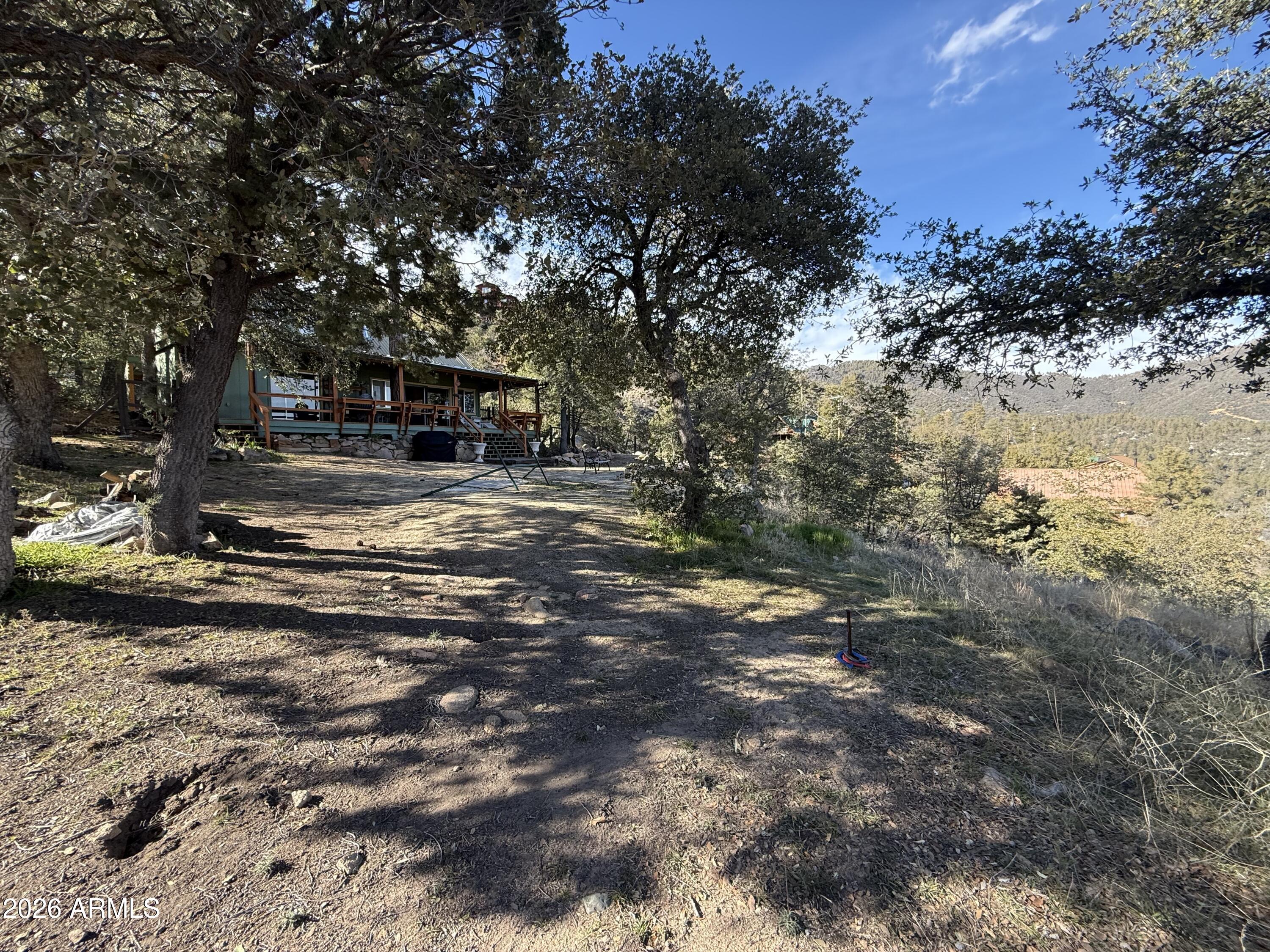 23487 Manzanita Road Crown King, AZ 86343 - Photo 10 of 41 a view of the house and yard with trees