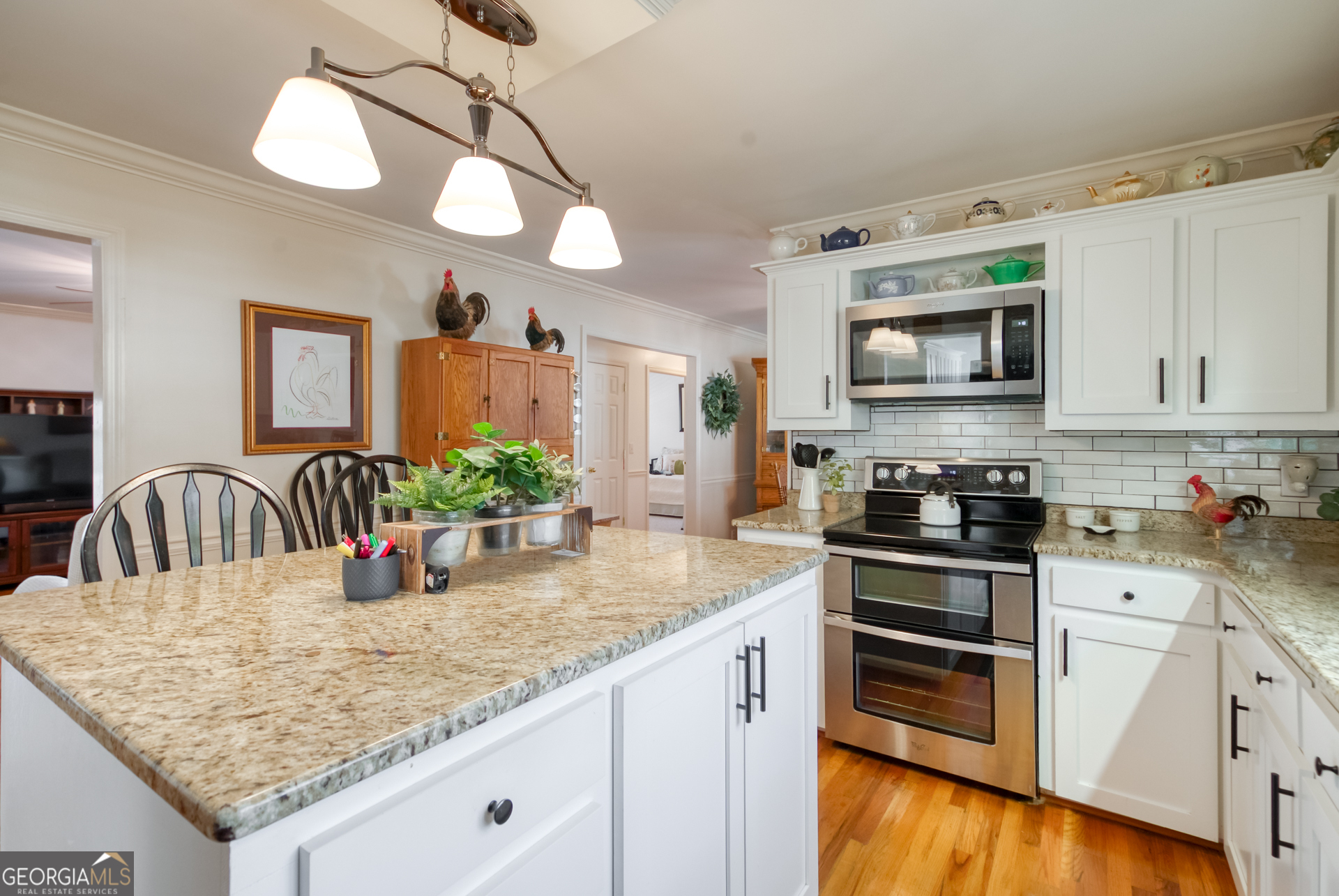 1650 Pierce Dairy Road Madison, GA 30650 - Photo 11 of 85 a kitchen with stainless steel appliances granite countertop a sink a stove and center island