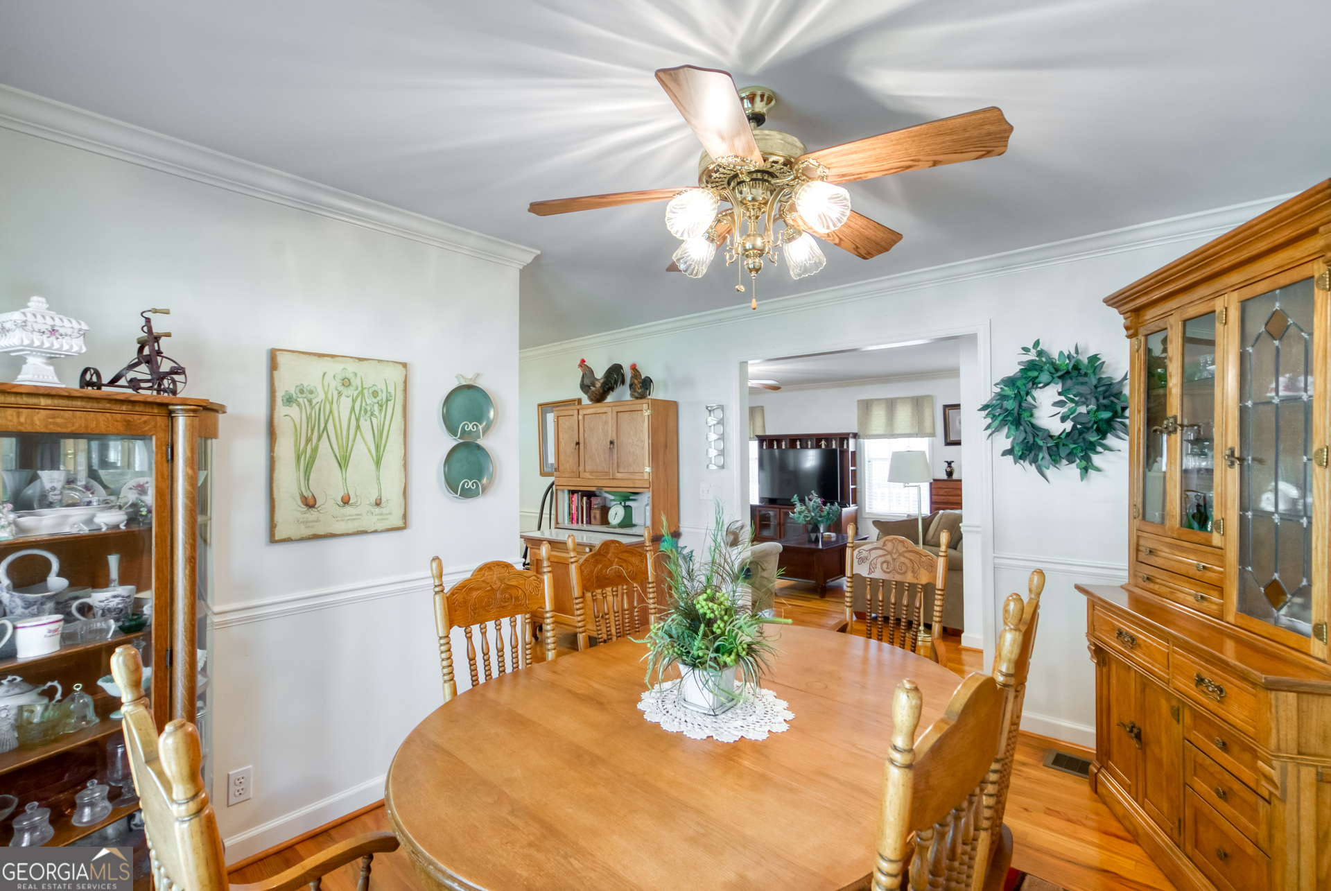 1650 Pierce Dairy Road Madison, GA 30650 - Photo 13 of 85 a dining room with furniture a painting a chandelier and wooden floor