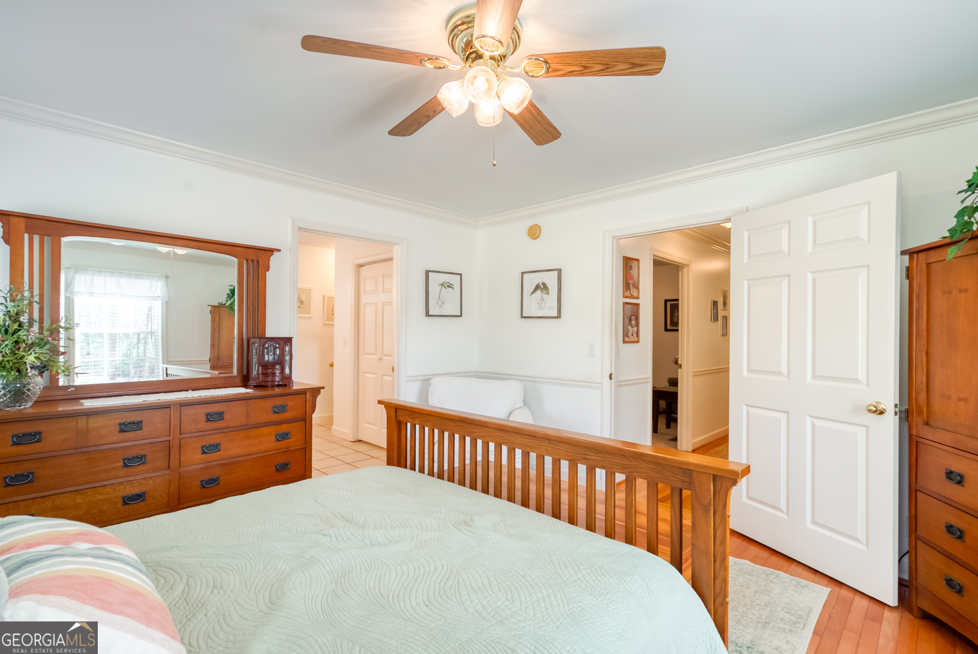 1650 Pierce Dairy Road Madison, GA 30650 - Photo 20 of 85 a bedroom with a bed and a chandelier