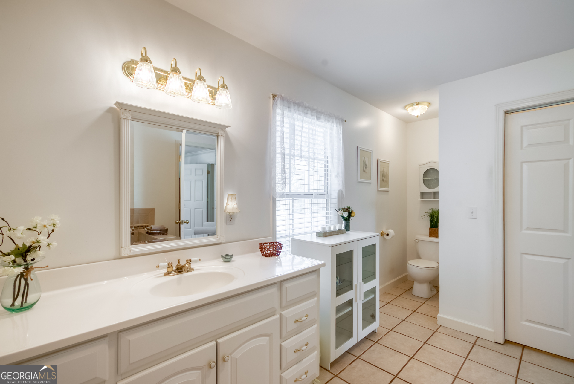 1650 Pierce Dairy Road Madison, GA 30650 - Photo 23 of 85 a bathroom with a sink double vanity and a mirror