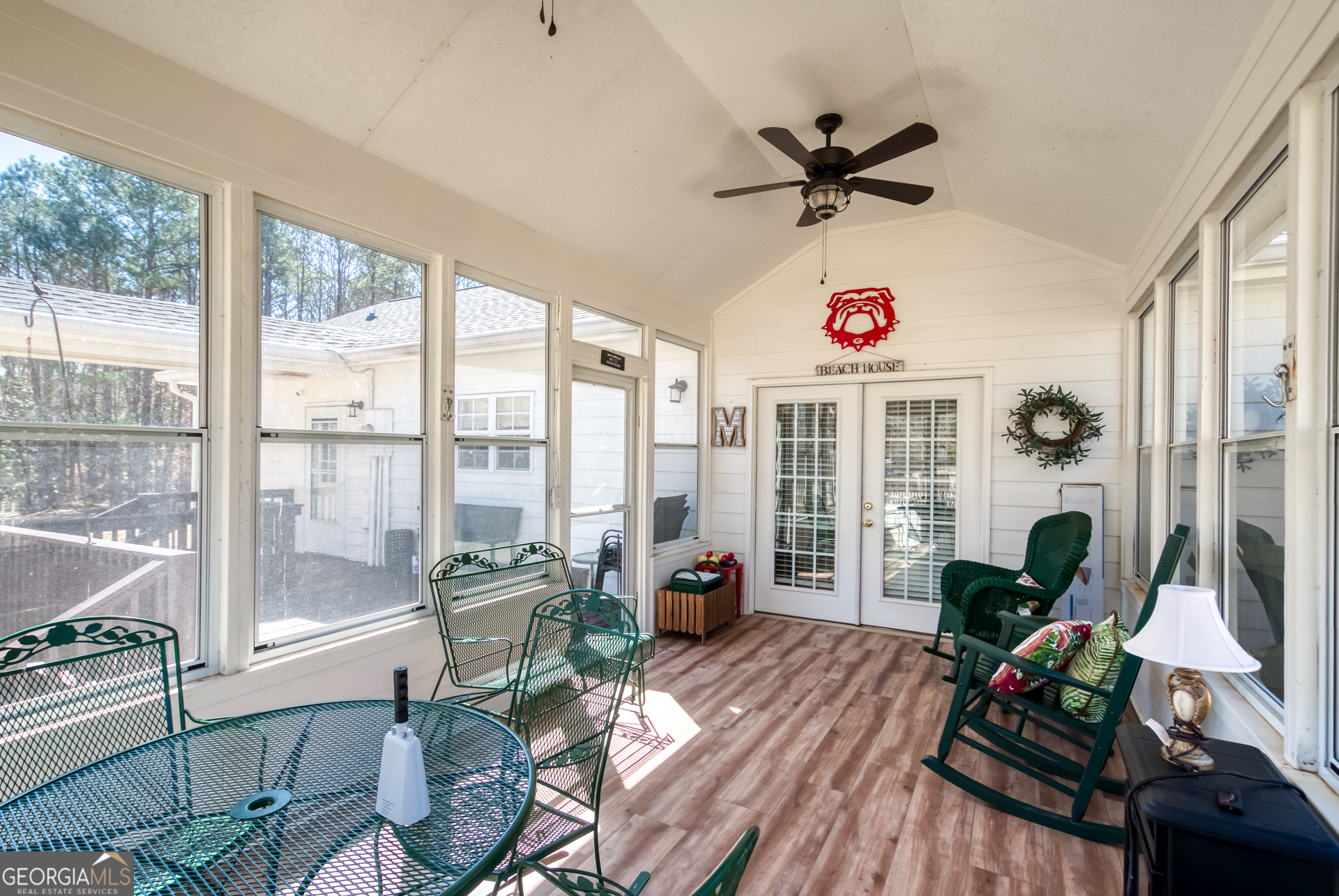 1650 Pierce Dairy Road Madison, GA 30650 - Photo 34 of 85 a living room with furniture a floor to ceiling window and a flat screen tv
