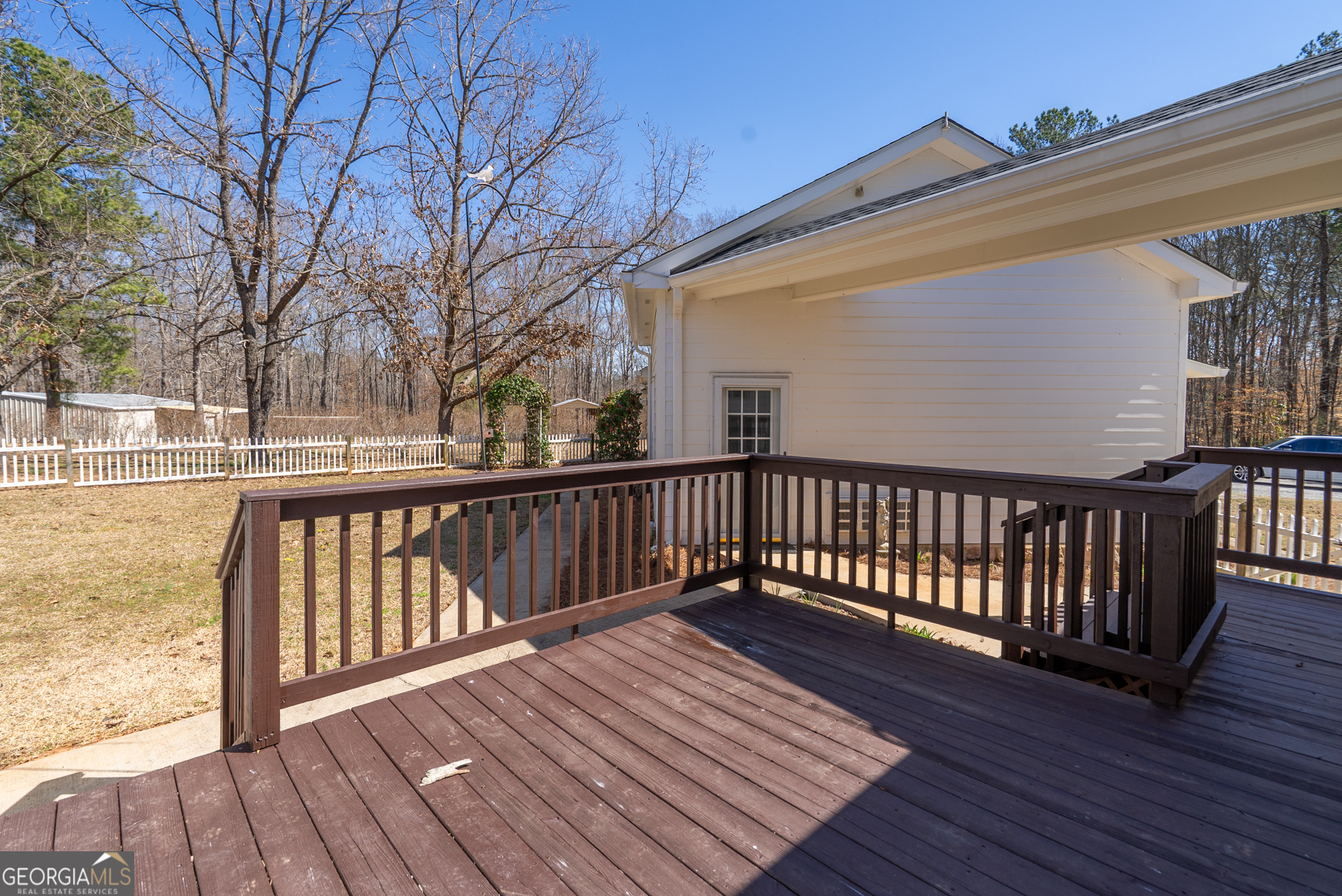 1650 Pierce Dairy Road Madison, GA 30650 - Photo 39 of 85 a view of balcony with wooden floor and fence