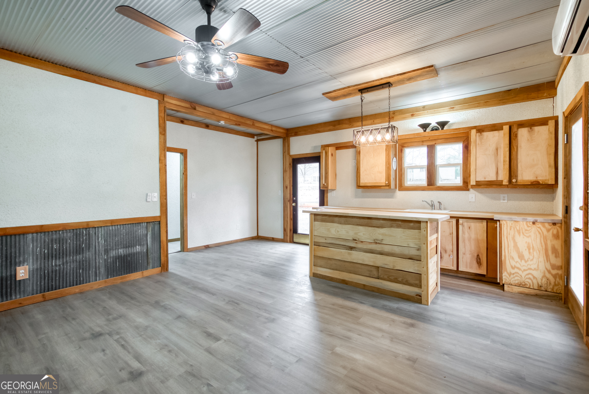 1650 Pierce Dairy Road Madison, GA 30650 - Photo 63 of 85 a view of an empty room with a window and wooden floor