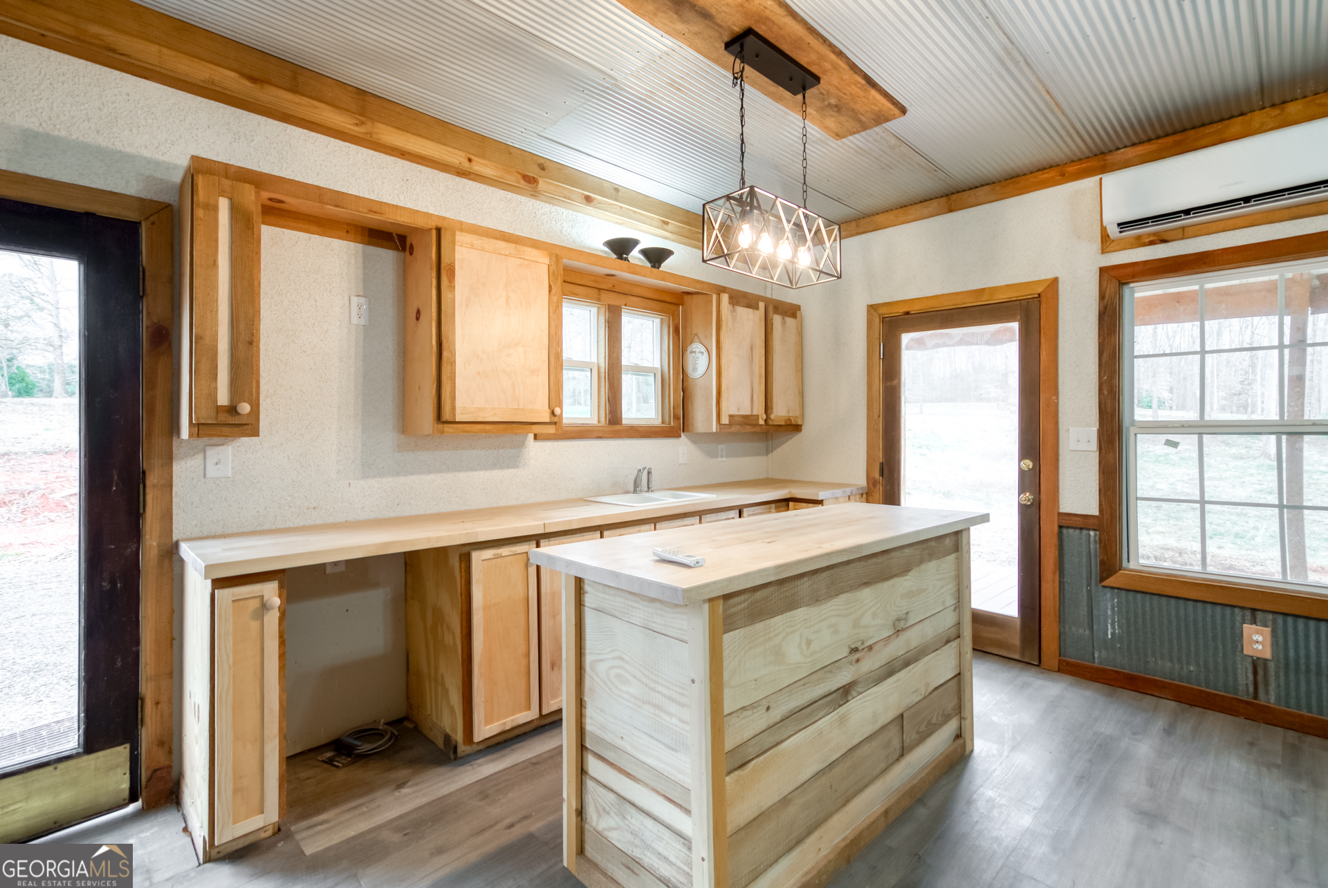 1650 Pierce Dairy Road Madison, GA 30650 - Photo 65 of 85 a kitchen that has a sink a stove and a table in it