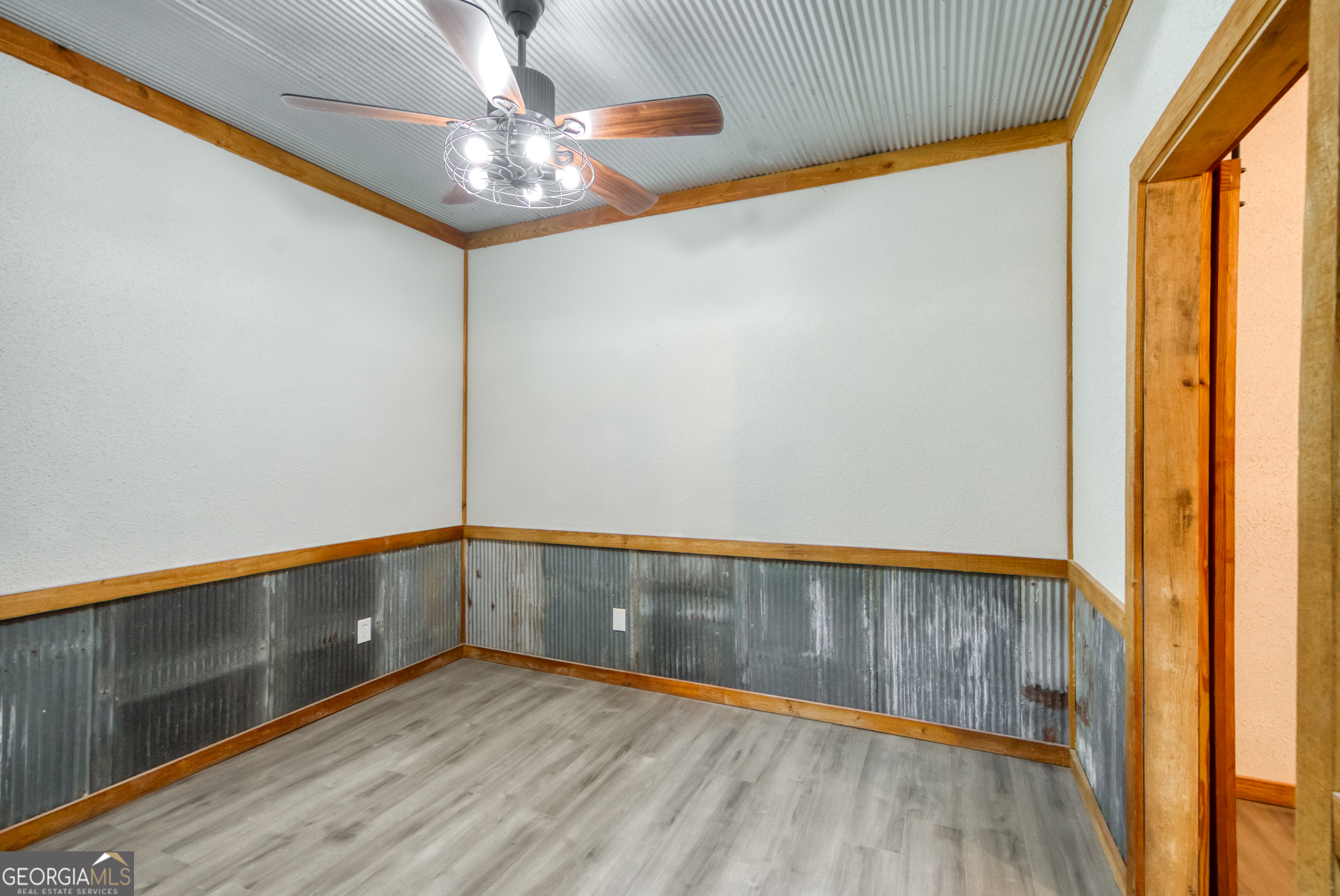 1650 Pierce Dairy Road Madison, GA 30650 - Photo 70 of 85 a view of an empty room with a window and wooden floor