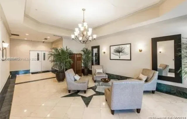a living room with furniture and a chandelier