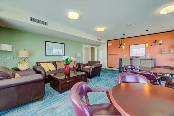 a living room with furniture a rug and a large window