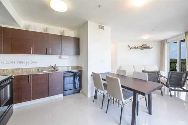 a kitchen with a table and chairs in it