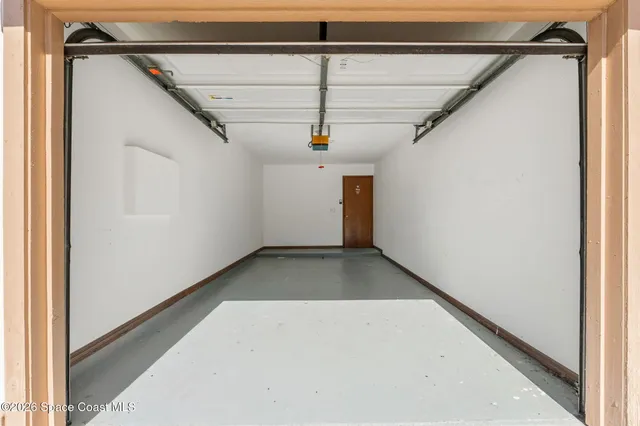 a living room with furniture and a book shelf