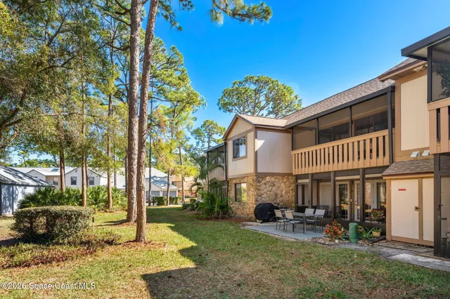 a room with lots of furniture and a dining table with wooden floor
