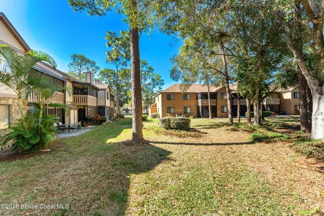 a view of a room with wooden floor and white walls